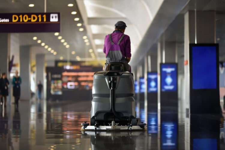 cleaning machine of floor scrubber with cleaner man in airport