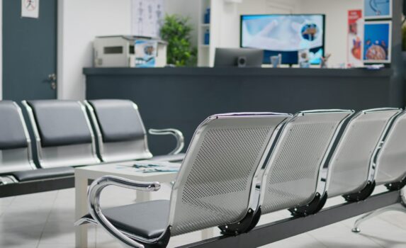 Empty hospital reception desk in waiting area lobby at medical health center, used to help patients with appointments and healthcare insurance. Clinical waiting area with counter.
