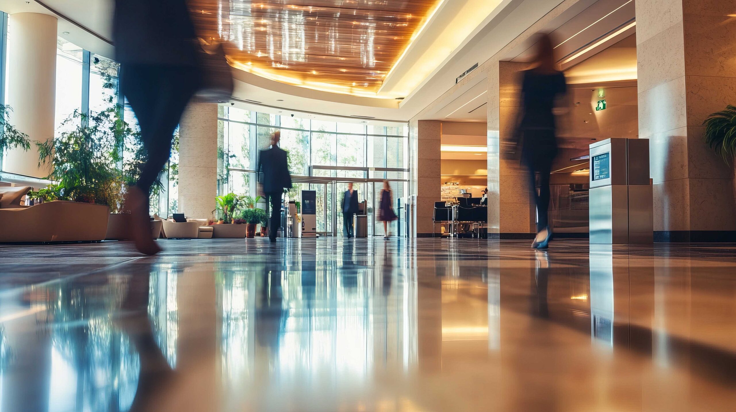 Soft focus busy modern hotel lobby motion blur people shiny floo